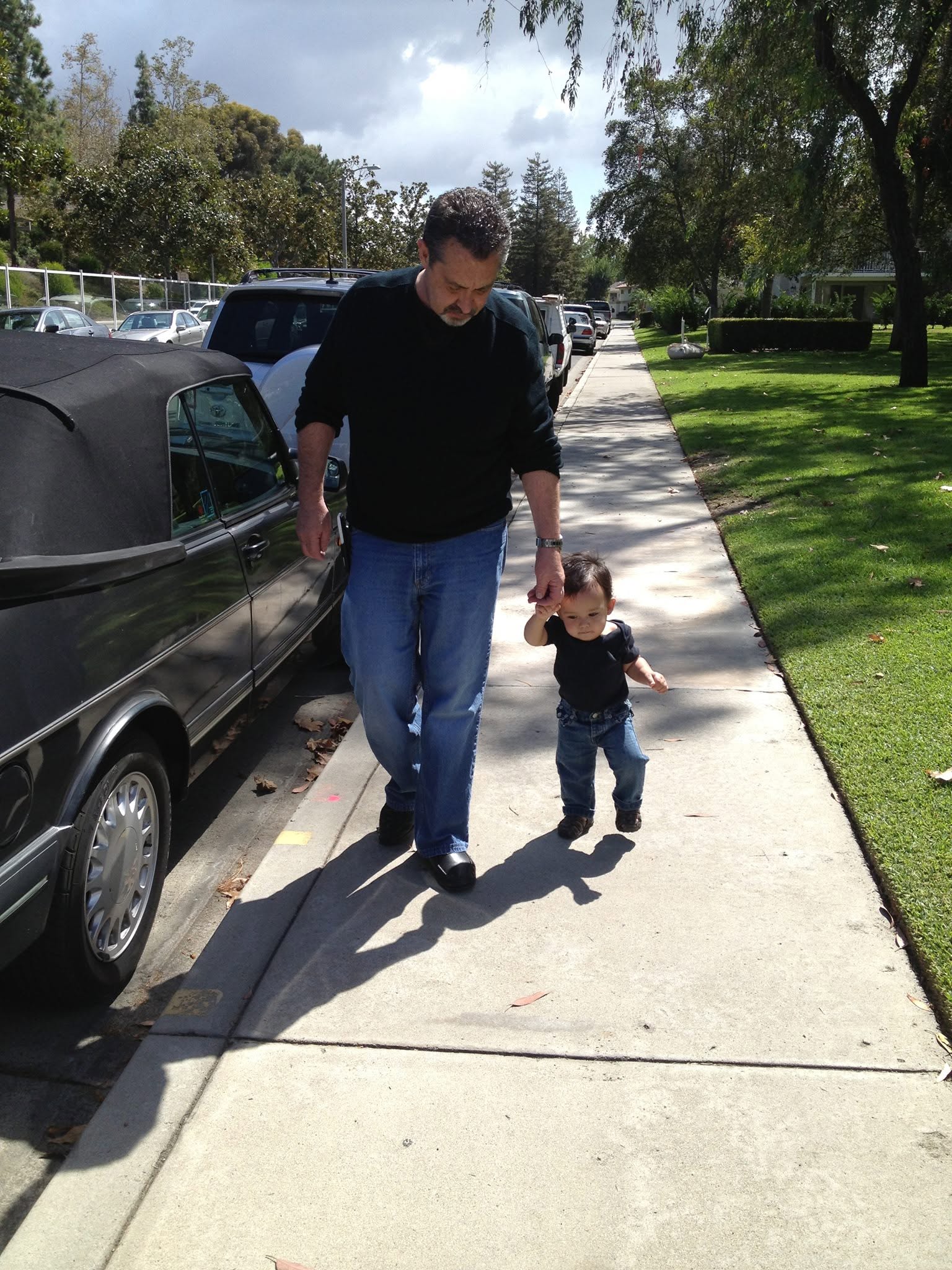 Eddie Wenrick walking hand-in-hand with a child